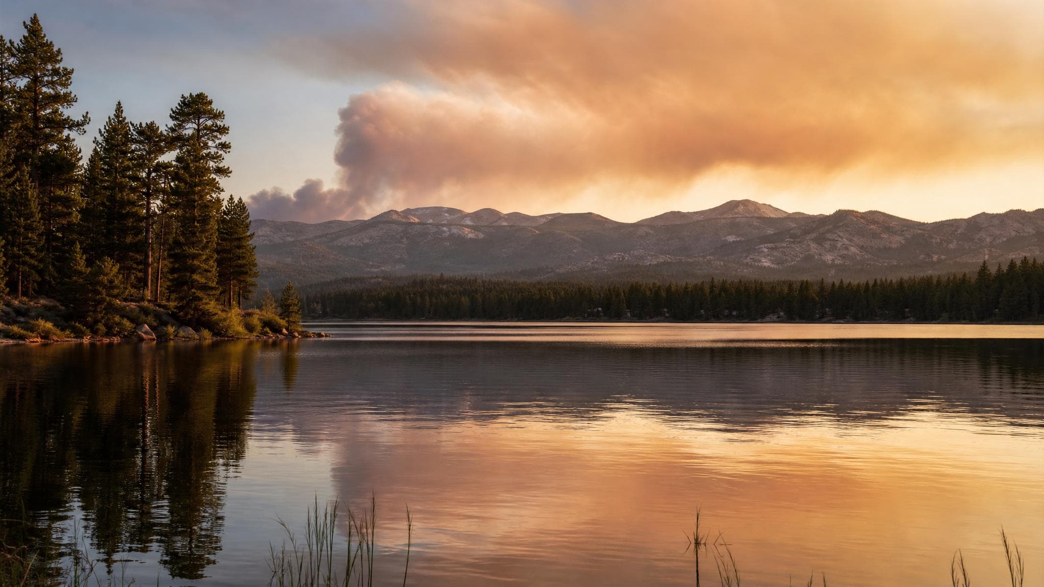 Wildfire smoke on a distant Silvermere mountain horizon above the lake.
